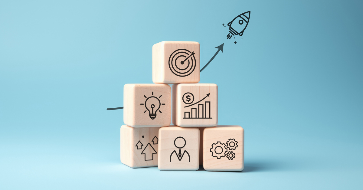 Rocket launching from wood cube with business icon