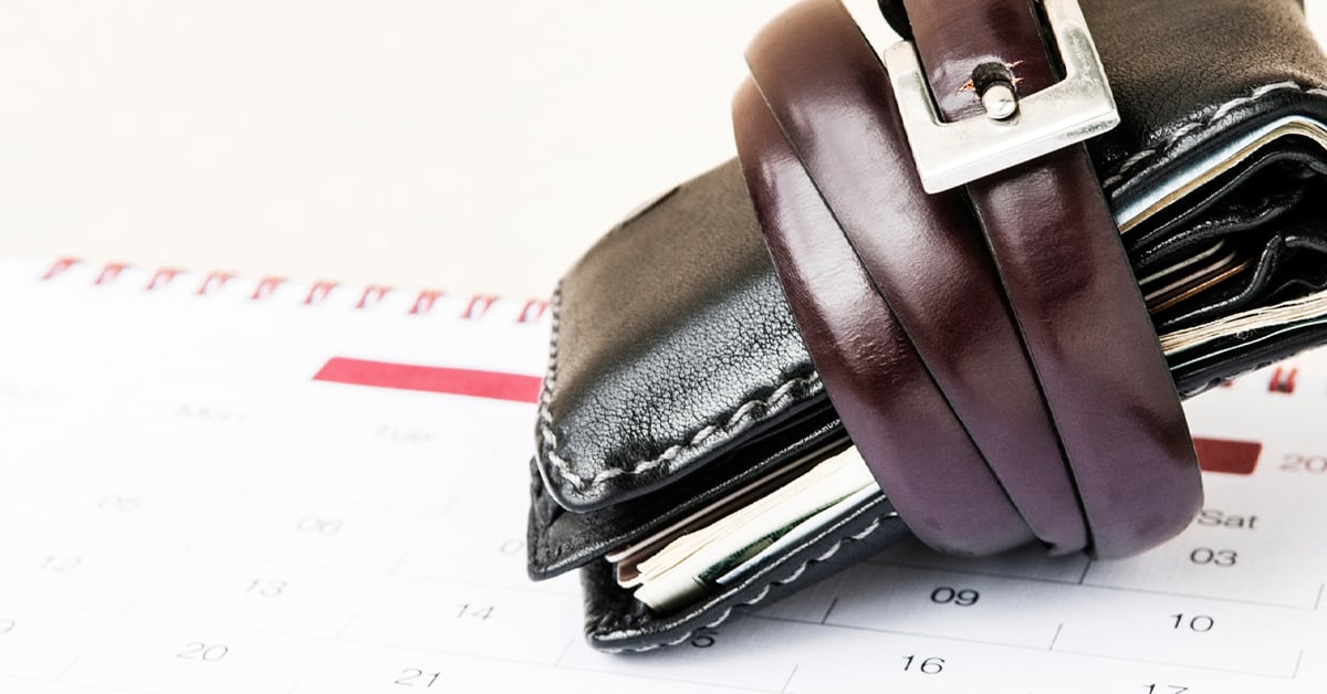 Wallet with a belt around it on a calendar